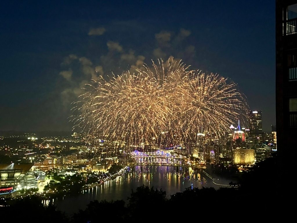 Fireworks over the Pittsburgh skyline at night